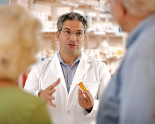 pharmacist talking to two older customers