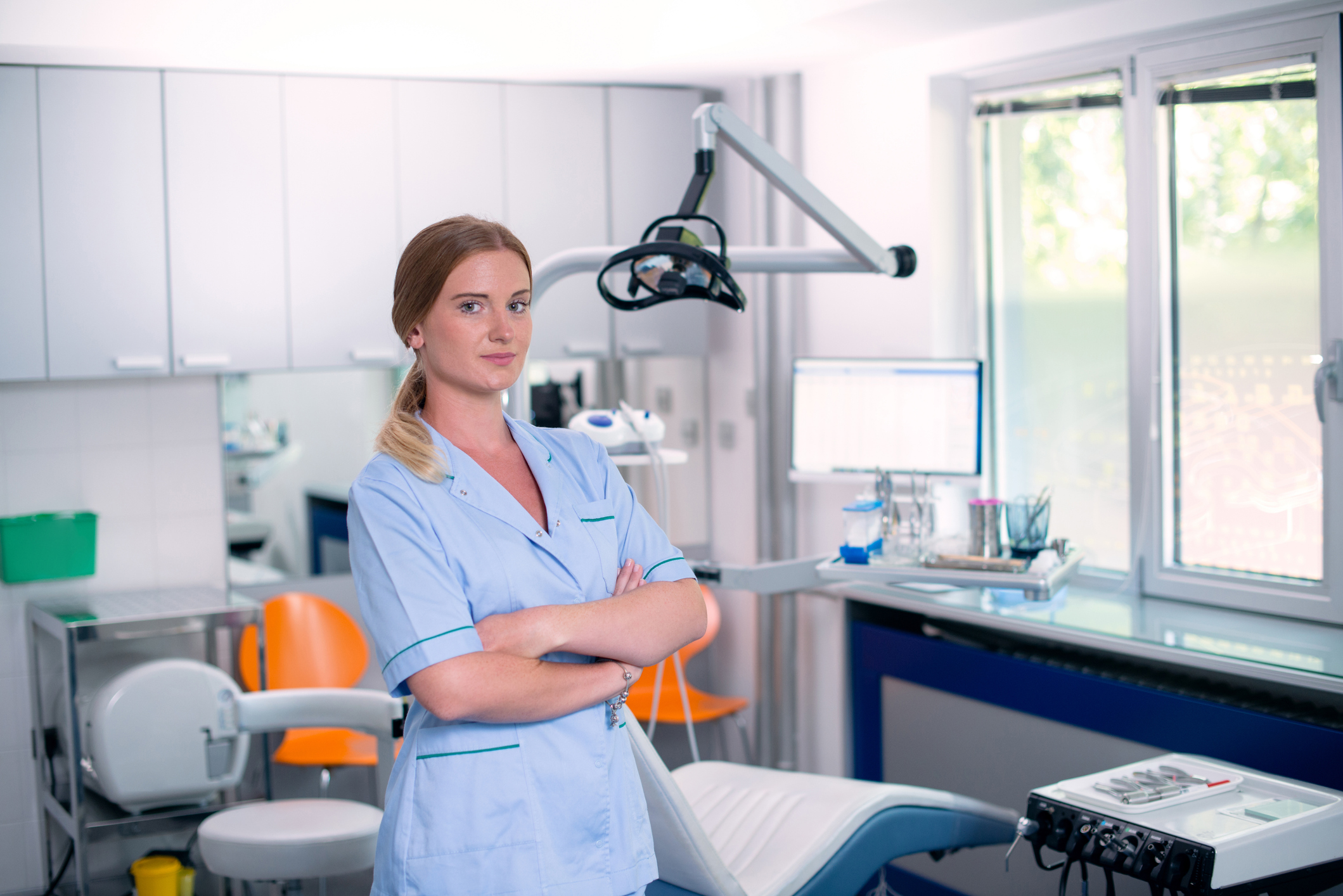 female dental professional standing in dentist office