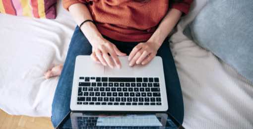 hand typing on a laptop